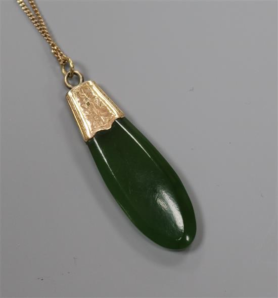 A yellow metal mounted jade pendant, on a 9ct gold fine link chain, pendant 42mm.
